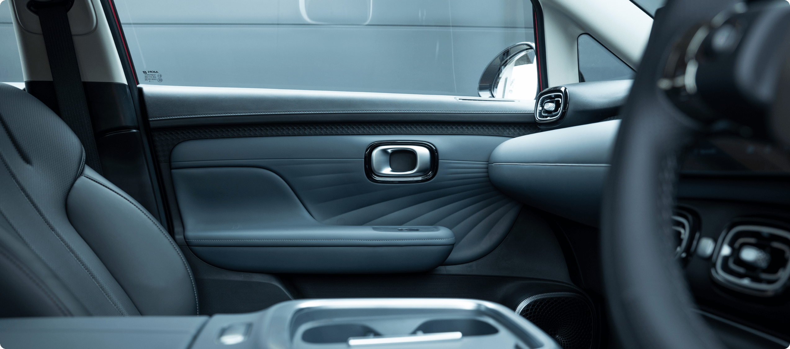 Close-up of a car's front passenger seat and door interior with modern design.
