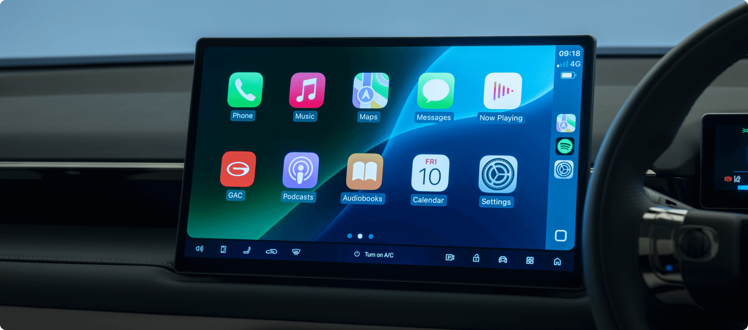 Car dashboard screen displaying app icons and system controls.