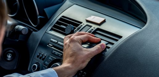 Car air conditioning vents blowing cool air inside vehicle