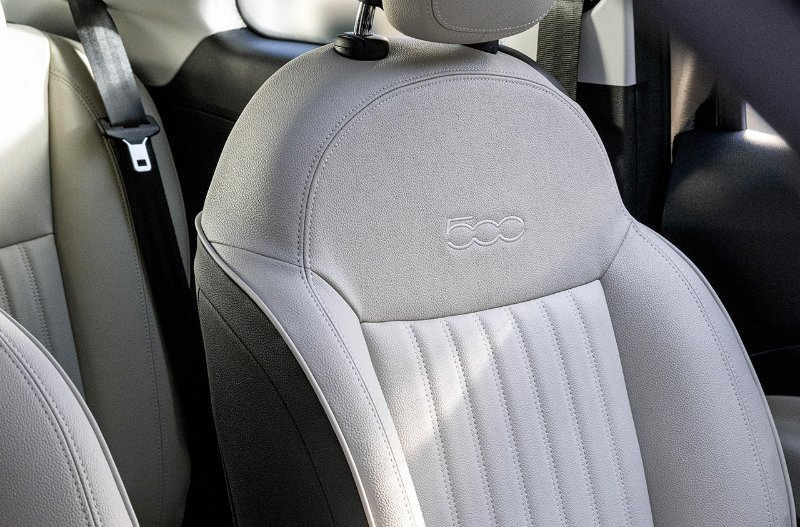 Close-up of a car seat with a stitched 500 logo on the headrest.